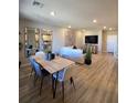 Bright, open-concept living and dining area with hardwood floors and modern decor at 2497 Rofrano Pl, Henderson, NV 89044