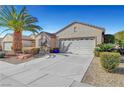 A well-maintained single-story home featuring desert landscaping and a two-car garage, set against a bright, blue sky at 2520 Eclipsing Stars Dr, Henderson, NV 89044