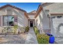 Inviting home exterior featuring a well-manicured front yard with desert landscaping and a two-car garage at 2520 Eclipsing Stars Dr, Henderson, NV 89044