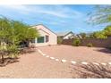 Large gravel backyard with stone accents, mature trees, and a peaceful setting at 2799 Alnwick Ct, Henderson, NV 89044