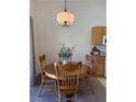 Inviting dining area featuring a round wooden table with chairs and a decorative lighting fixture at 3360 Cactus Shadow St # 203, Las Vegas, NV 89129