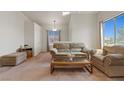 Inviting living room with plush seating, soft carpet, and bright natural light from large windows at 3360 Cactus Shadow St # 203, Las Vegas, NV 89129
