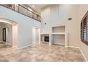 Open concept living room with fireplace, tile flooring, and natural light at 368 Misty Moonlight St, Henderson, NV 89015
