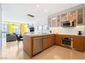 Sleek, open kitchen flows to a living room with contemporary pendant lighting and stainless steel appliances at 3726 Las Vegas Blvd # 2410, Las Vegas, NV 89158