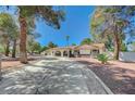 Expansive driveway and desert landscaping accent this bright single-story home at 4030 Del Monte Ave, Las Vegas, NV 89102
