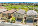 Aerial view of a two-story house showing backyard, neighborhood, community park and mountain views at 4511 Stardusk Falls Ave, North Las Vegas, NV 89084
