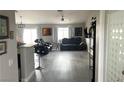 Open-concept living area featuring sleek flooring, a modern ceiling fan, and two comfortable reclining sofas at 4618 Zia Ridge St, North Las Vegas, NV 89031
