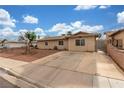 Charming single-story home featuring desert landscaping, a long driveway, and secure gated access in the front at 5109 Gains Mill St, Las Vegas, NV 89122