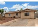Charming single-story home featuring desert landscaping, a long driveway, and secure gated access in the front at 5109 Gains Mill St, Las Vegas, NV 89122
