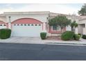 Home featuring an attached garage and beautiful landscaping at 5165 Briar Meadow Way, Las Vegas, NV 89118