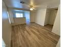 Bright living room boasts wood-look flooring and a view into an adjacent living space at 5474 Jacobs Field St, Las Vegas, NV 89148