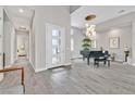Grand foyer with high ceilings, piano, and wood look tile flooring at 6184 Willow Rock St, Las Vegas, NV 89135