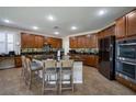 Kitchen with dark granite counters, a large island, stainless appliances, and abundant cabinet space at 7520 Fontera Ct, Las Vegas, NV 89139