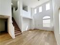 Spacious living room features high ceilings, hardwood floors, and a staircase at 7863 Warwickshire Way, Las Vegas, NV 89139