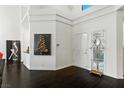 Bright entryway with dark wood floors, high ceilings and a decorative mirror at 7988 Harbour Towne Ave, Las Vegas, NV 89113