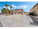 Inviting two-story home with a spacious three-car garage and mature palm trees at 8320 Deer Springs Way, Las Vegas, NV 89149