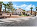 Charming two-story home with desert landscaping and lush green accents at 8320 Deer Springs Way, Las Vegas, NV 89149