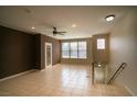 Spacious living room with tile flooring, ceiling fan, and ample natural light from large windows at 8555 W Russell Rd # 2020, Las Vegas, NV 89113