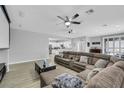 Open living room with a large sectional sofa, media setup, and an open floor plan at 8836 Martin Downs Pl, Las Vegas, NV 89131