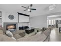 Cozy living room with fireplace, large screen, and comfortable sectional seating at 8836 Martin Downs Pl, Las Vegas, NV 89131