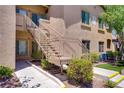 Exterior stairs lead to upper-level condos, complemented by manicured landscaping at 8985 S Durango Dr # 1154, Las Vegas, NV 89113