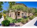 Building exterior with well-maintained landscaping, mature trees, and inviting walkway at 8985 S Durango Dr # 1154, Las Vegas, NV 89113