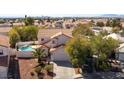 Aerial view of home with pool, landscaping, and view of the city at 1011 Pearl Marble Ave, North Las Vegas, NV 89081