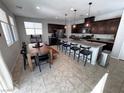 Spacious kitchen with granite countertops, stainless steel appliances, large island, and adjacent dining area at 10383 Andele Ave, Las Vegas, NV 89166