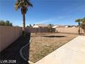Lush backyard with a concrete border and desert landscaping, complete with palm trees at 1083 Sterling Peak St, Las Vegas, NV 89110