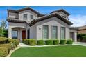 Stylish home with a well-kept lawn, neat landscaping, and a welcoming entrance at 11 Morninglow Pass, Henderson, NV 89052