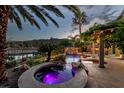 Backyard view of the hot tub and custom waterfall feature flowing into the pool, an inviting outdoor paradise at 11359 Winter Cottage Pl, Las Vegas, NV 89135