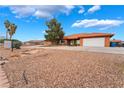 Well-maintained home featuring desert landscaping, a spacious driveway, and a 'For Sale' sign at 120 N Phyllis St, Las Vegas, NV 89110