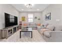 Cozy living room with a large sectional sofa, a TV, and a playful atmosphere at 14 Parco Fiore Ct, Henderson, NV 89011