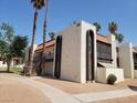 Exterior of a stucco-sided unit with dark brown trim, tile roof, and desert landscaping at 1405 Vegas Valley Dr # 270, Las Vegas, NV 89169
