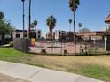 Community pool with a black metal fence and surrounding landscaping at 1405 Vegas Valley Dr # 270, Las Vegas, NV 89169