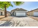 Attractive single-story residence showcasing a neat front yard, long drive way and attached garage at 1714 Ringe Ln, Las Vegas, NV 89156