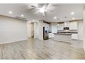 Open-concept living space with wood-look tile flooring and recessed lighting at 172 Petaluma Valley Dr, Las Vegas, NV 89138