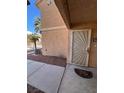 Condominium entrance featuring a decorative security screen door and well-kept landscaping at 1830 N Pecos Rd # 155, Las Vegas, NV 89115