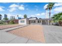 Attractive single-story home boasting desert landscaping, carport, and a glimpse of the iconic Stratosphere Tower at 2112 Santa Ynez Dr, Las Vegas, NV 89104