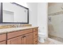 Bathroom featuring granite countertop, framed mirror, and shower with neutral tile at 2615 W Gary Ave # 1041, Las Vegas, NV 89123