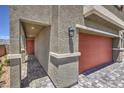 Covered entry featuring a brick-paved walkway leading to the front door and a two-car garage at 2633 Begonia Falls Ave # 88, North Las Vegas, NV 89081