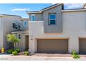 Modern townhouse exterior featuring a two-car garage and well-maintained landscaping at 2691 Mango Light Ave, North Las Vegas, NV 89086