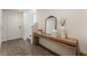 Inviting foyer with wood-look floors, decor, and a console table beneath a decorative mirror at 2691 Mango Light Ave, North Las Vegas, NV 89086