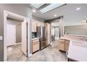 Spacious kitchen with stainless steel fridge, light cabinets, and adjacent breakfast nook at 2810 Somerset Springs Dr, Henderson, NV 89052