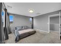 Cozy bedroom with soft carpet, neutral gray walls, and ample natural light from multiple windows at 3192 Timorasso Ave, Henderson, NV 89044