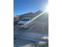 Exterior front view of the house with white truck and a wrought iron fence at 3443 Citruscedar Way, North Las Vegas, NV 89032