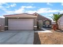 Charming single-story home featuring desert landscaping, with a two-car garage and covered entry at 3443 Citruscedar Way, North Las Vegas, NV 89032