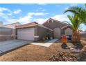 Charming single-story home featuring desert landscaping, with a two-car garage and covered entry at 3443 Citruscedar Way, North Las Vegas, NV 89032