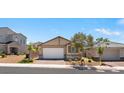 Charming single-story home featuring a brick driveway, two-car garage, desert landscaping, and neutral paint scheme at 3709 Neblina Dr, Henderson, NV 89052