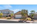 Charming single-story home featuring a brick driveway, a two-car garage, neutral paint, and mature landscaping at 3709 Neblina Dr, Henderson, NV 89052